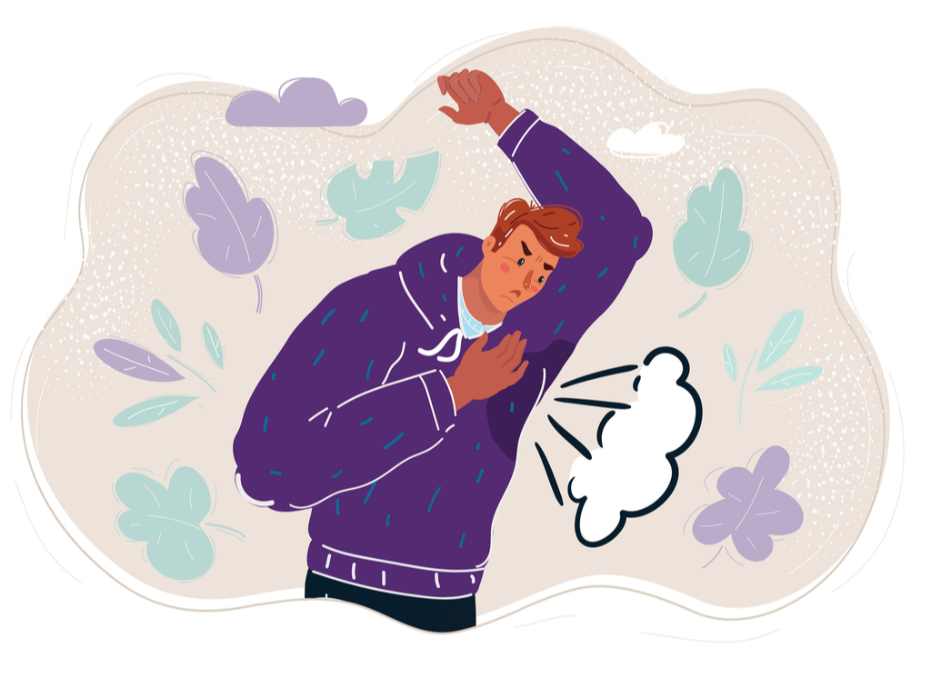Man in purple hoody holding his left arm in the air, looking angrily at his armpit which is wet and looks smelly